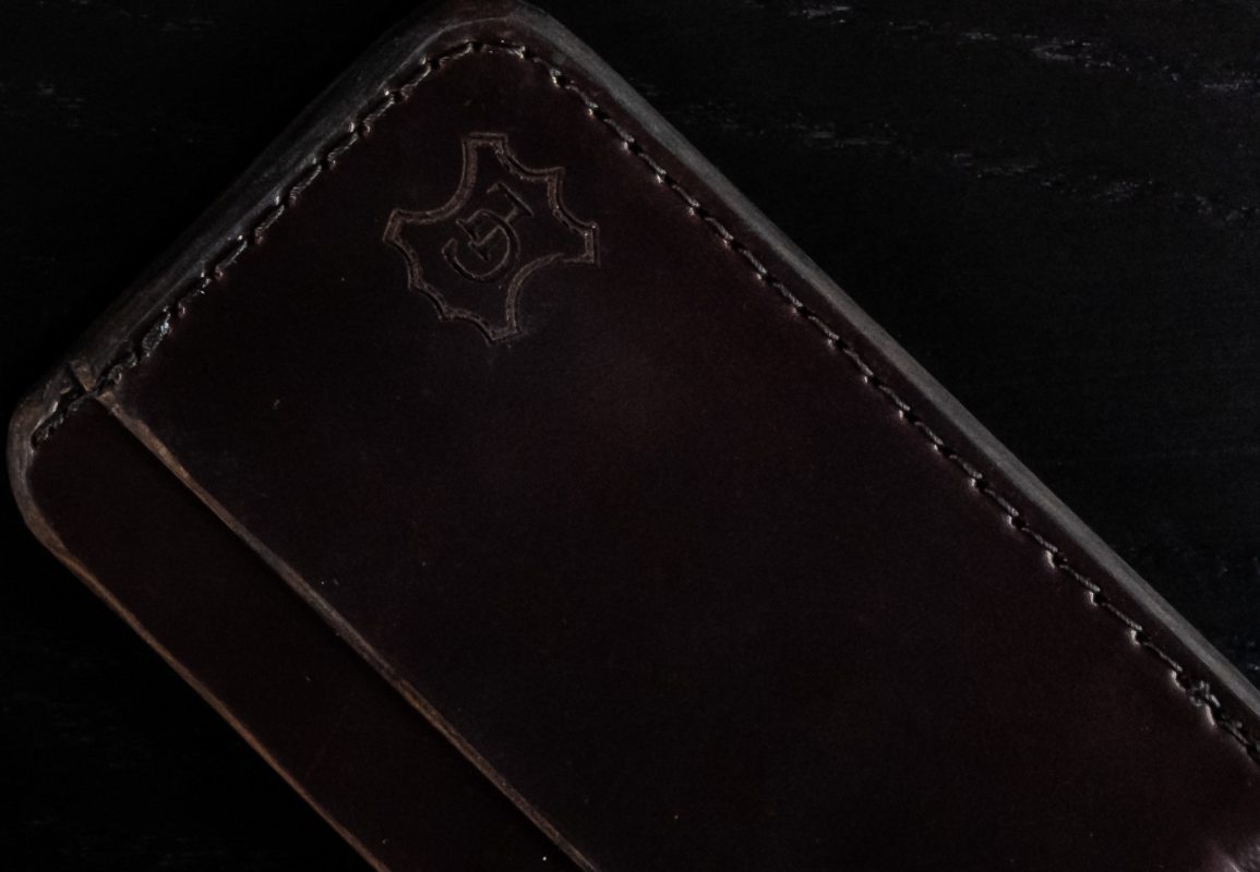 a brown wallet sitting on top of a table.