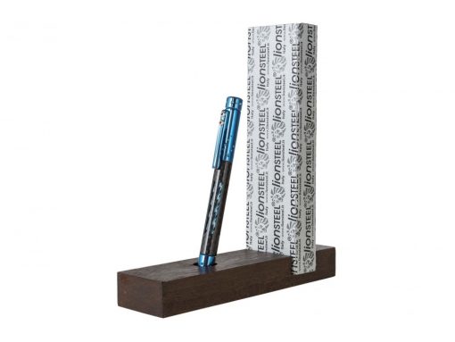 The Lionsteel Nyala Titanium/Carbon Fiber Pen (Blue Shine) sitting on top of a wooden stand.