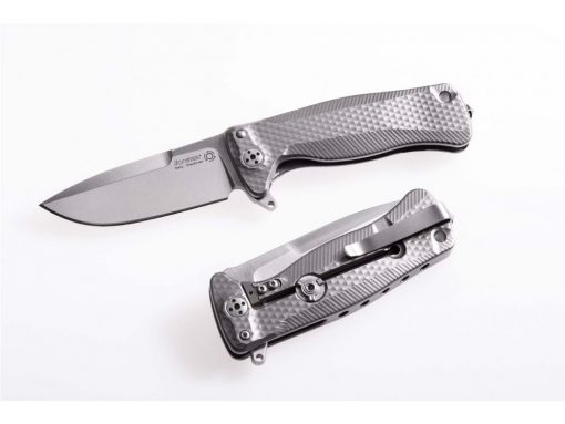 A LionSteel SR-22 Flipper Integral Frame Lock Knife (3.125" Satin) M390 Blade Titanium Handle sitting on top of another one.