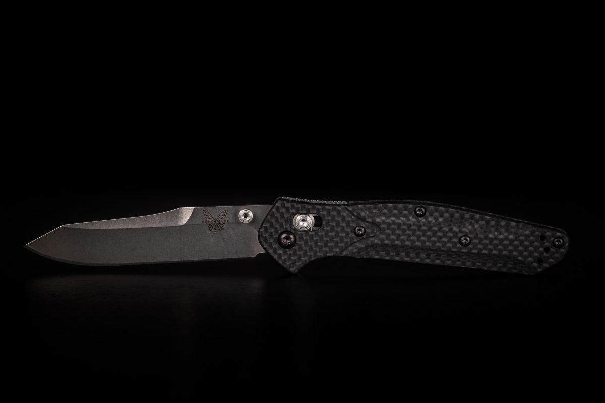 a knife with a black handle on a black background.