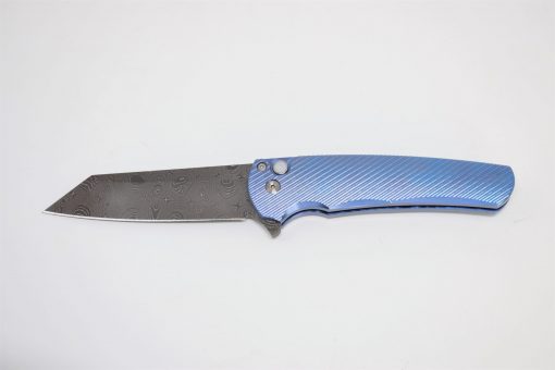 A ProTech Malibu Reverse Tanto Damascus Blade 3D Blue Titanium Handle on a white background.