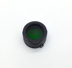 A close up of a Fenix AD302G TK-Series Green Filter Adapter on a white surface.