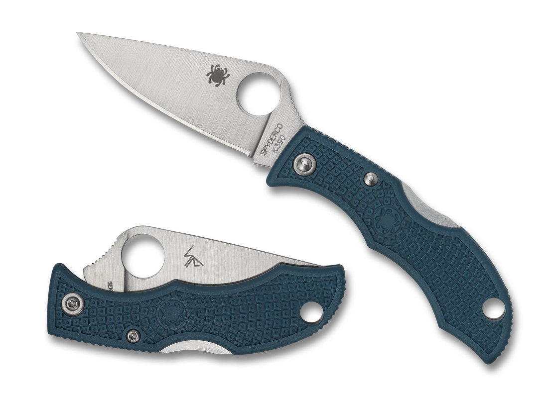 a pair of blue and silver scissors on a green background.