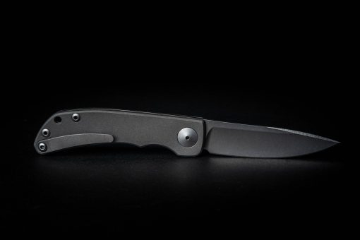 Chris Reeve Knives Impinda "The Climb" Slip Joint Knife S35VN Blade Titanium Handle With CAD Engraving on a black background.