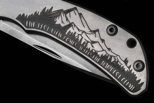 A close up of a Chris Reeve Knives Impinda "The Climb" Slip Joint Knife with S35VN Blade and Titanium Handle with CAD Engraving on a black background.