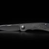A Chris Reeve Knives Impinda "The Climb" slip joint knife with a titanium handle and CAD engraving on a black background.