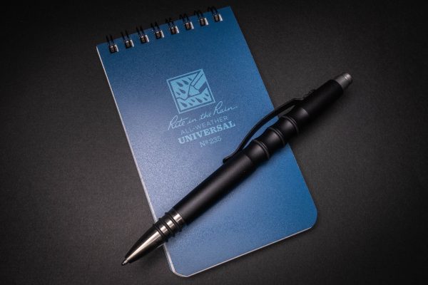 a pen sitting on top of a notebook.